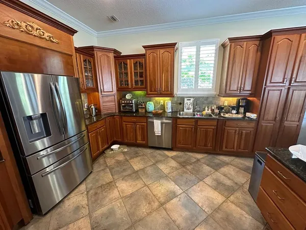 a kitchen with stainless steel appliances granite countertop a refrigerator sink and cabinets