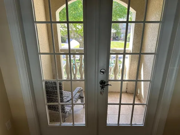 a bedroom with a bed wooden floor and a flat screen tv