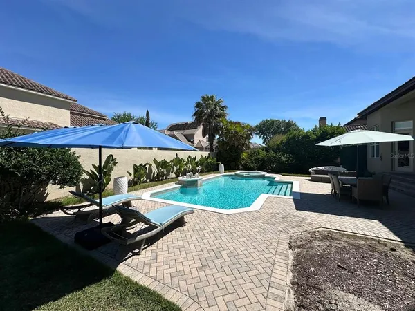 a view of an outdoor space with furniture and umbrella