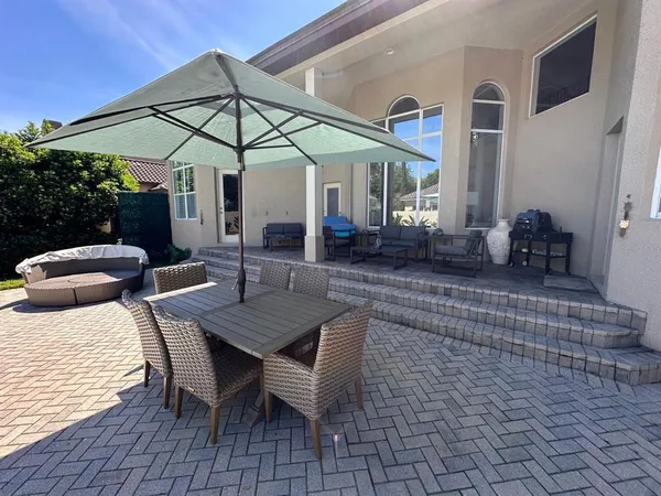 a view of a backyard with sitting area