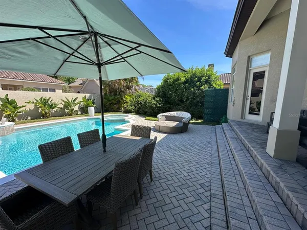 a view of a swimming pool with a patio
