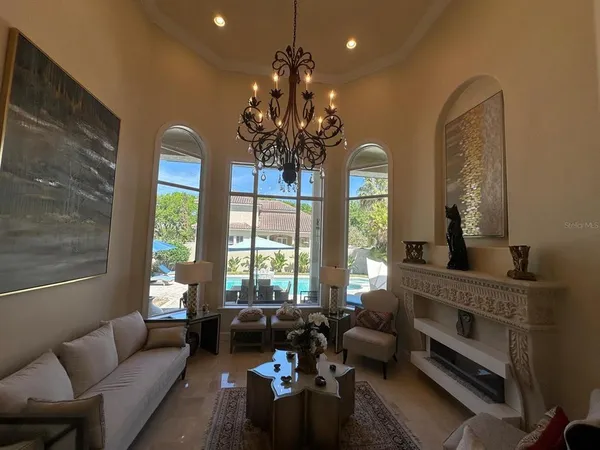 a living room with furniture and a chandelier