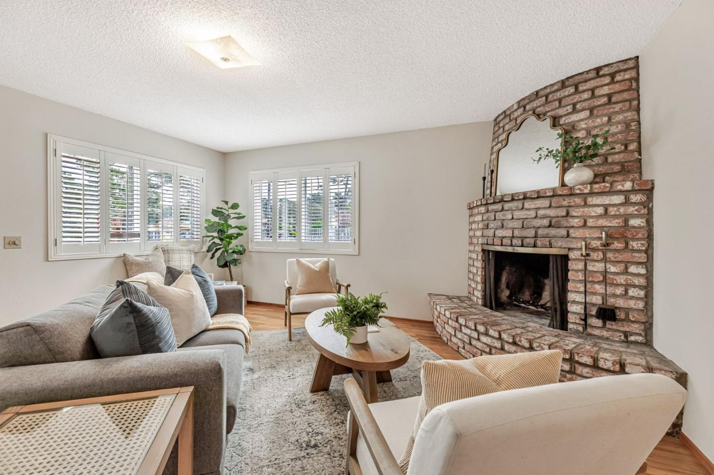 a living room with furniture a large window and a fireplace