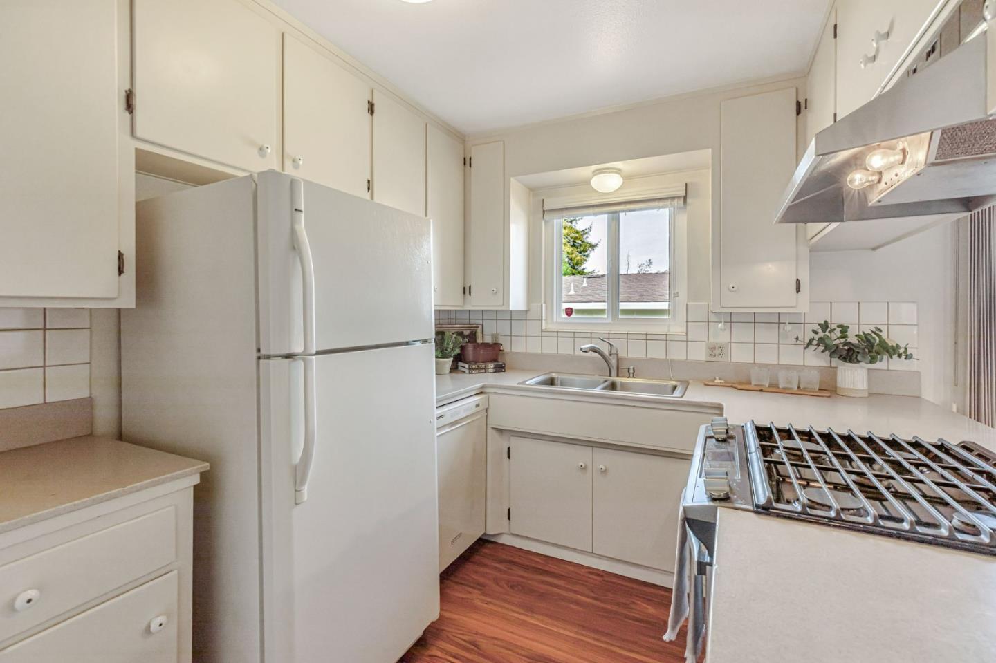 801 Lobos Street Monterey, CA 93940 - Photo 11 of 43 a kitchen with a sink a refrigerator a washer and dryer