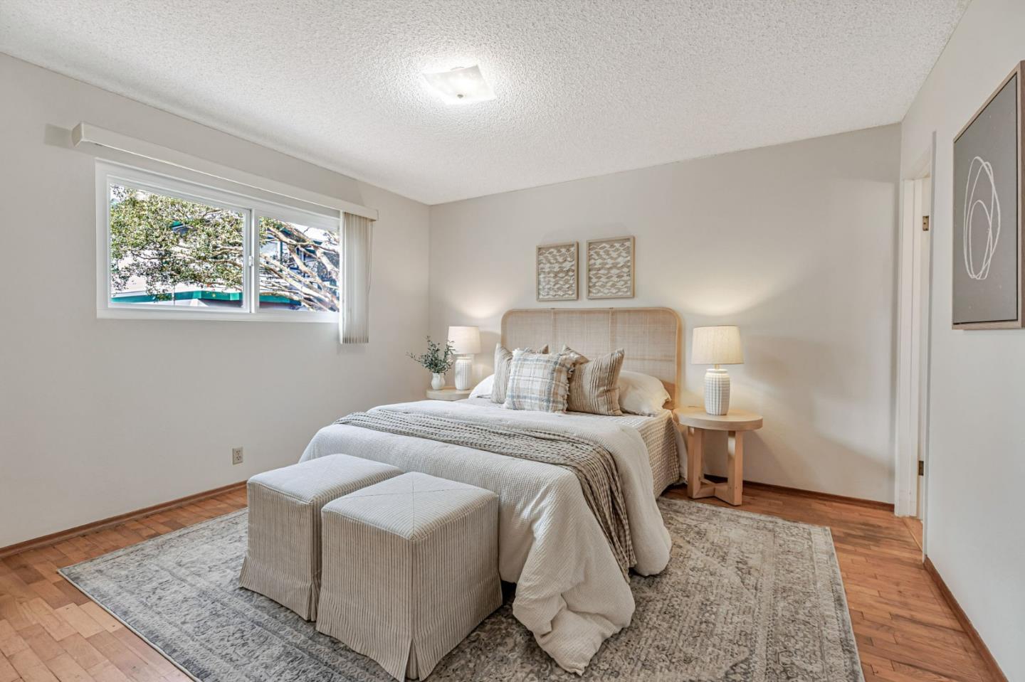 801 Lobos Street Monterey, CA 93940 - Photo 15 of 43 a bedroom with a bed and a painting on the wall