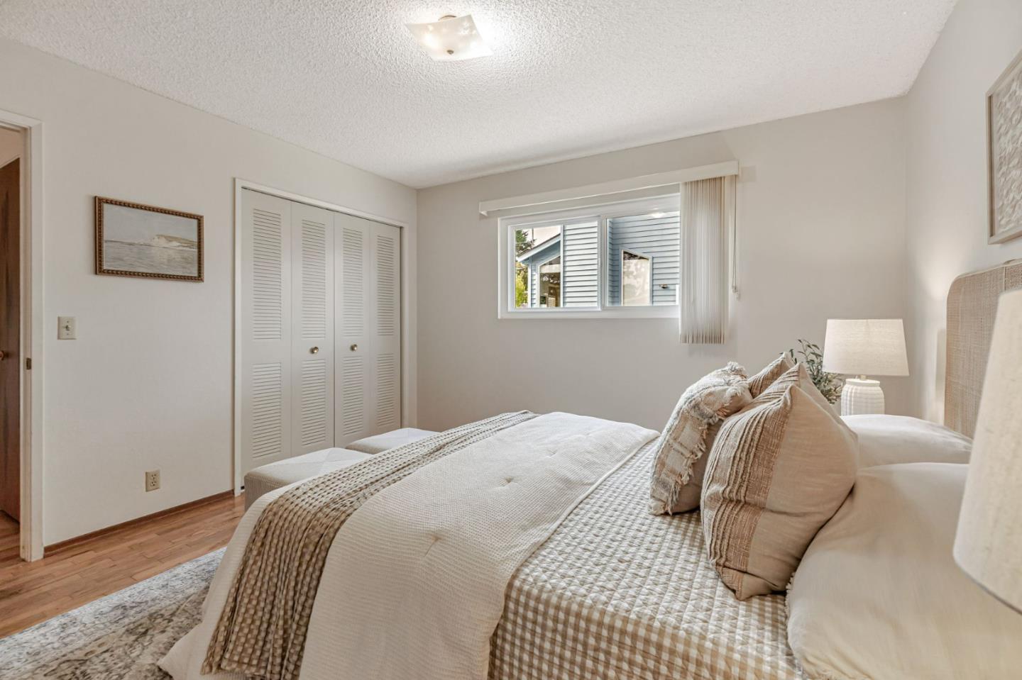 801 Lobos Street Monterey, CA 93940 - Photo 17 of 43 a bedroom with a bed and wooden floor