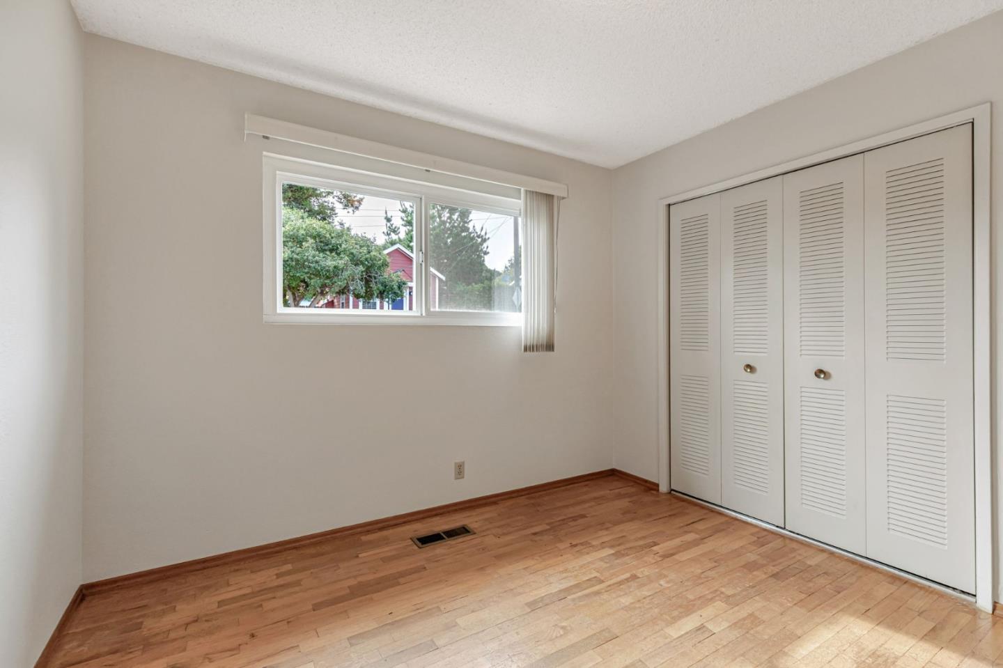 801 Lobos Street Monterey, CA 93940 - Photo 22 of 43 a view of an empty room with wooden floor and a window