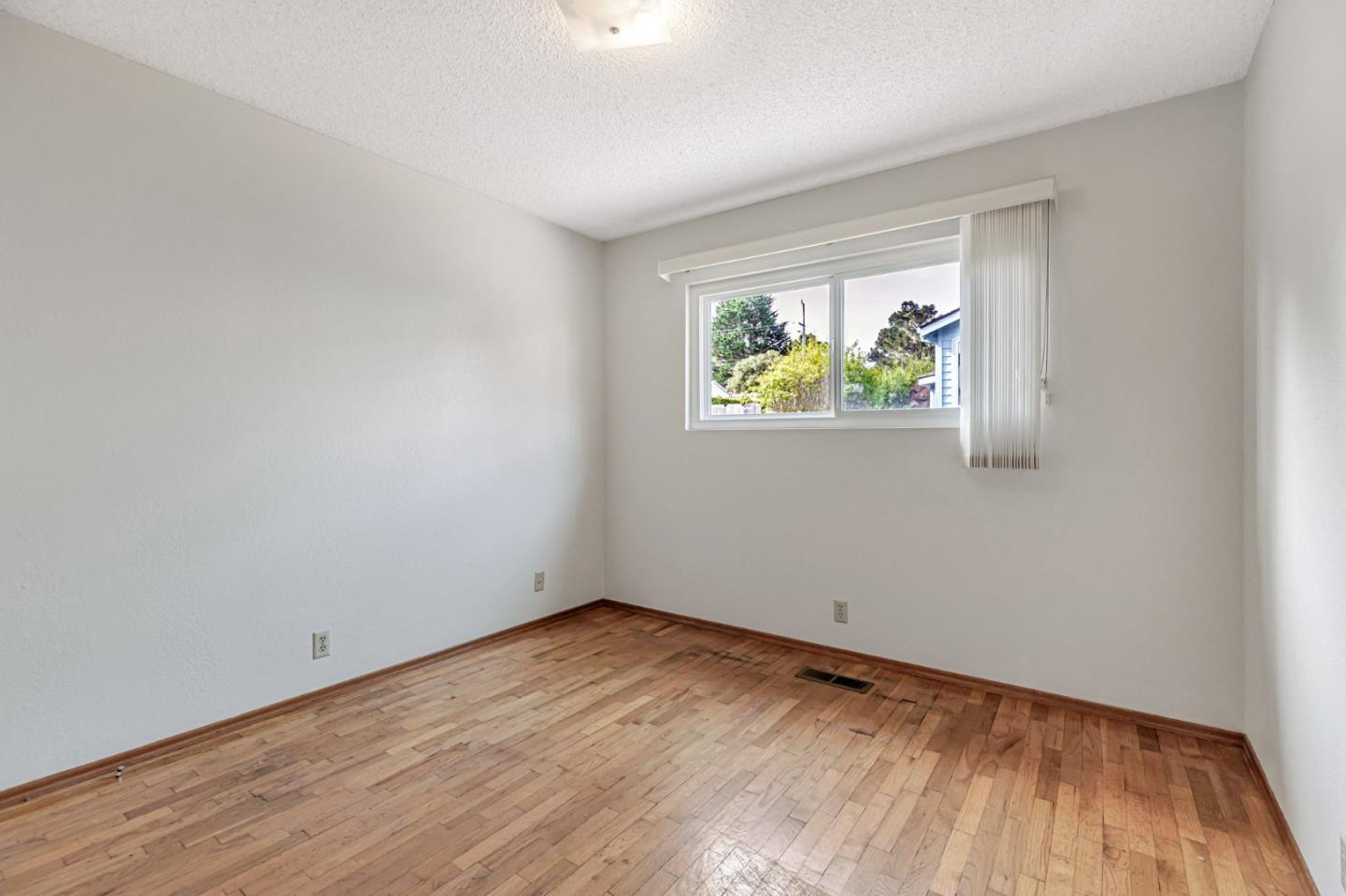 801 Lobos Street Monterey, CA 93940 - Photo 25 of 43 a view of room with window and wooden floor