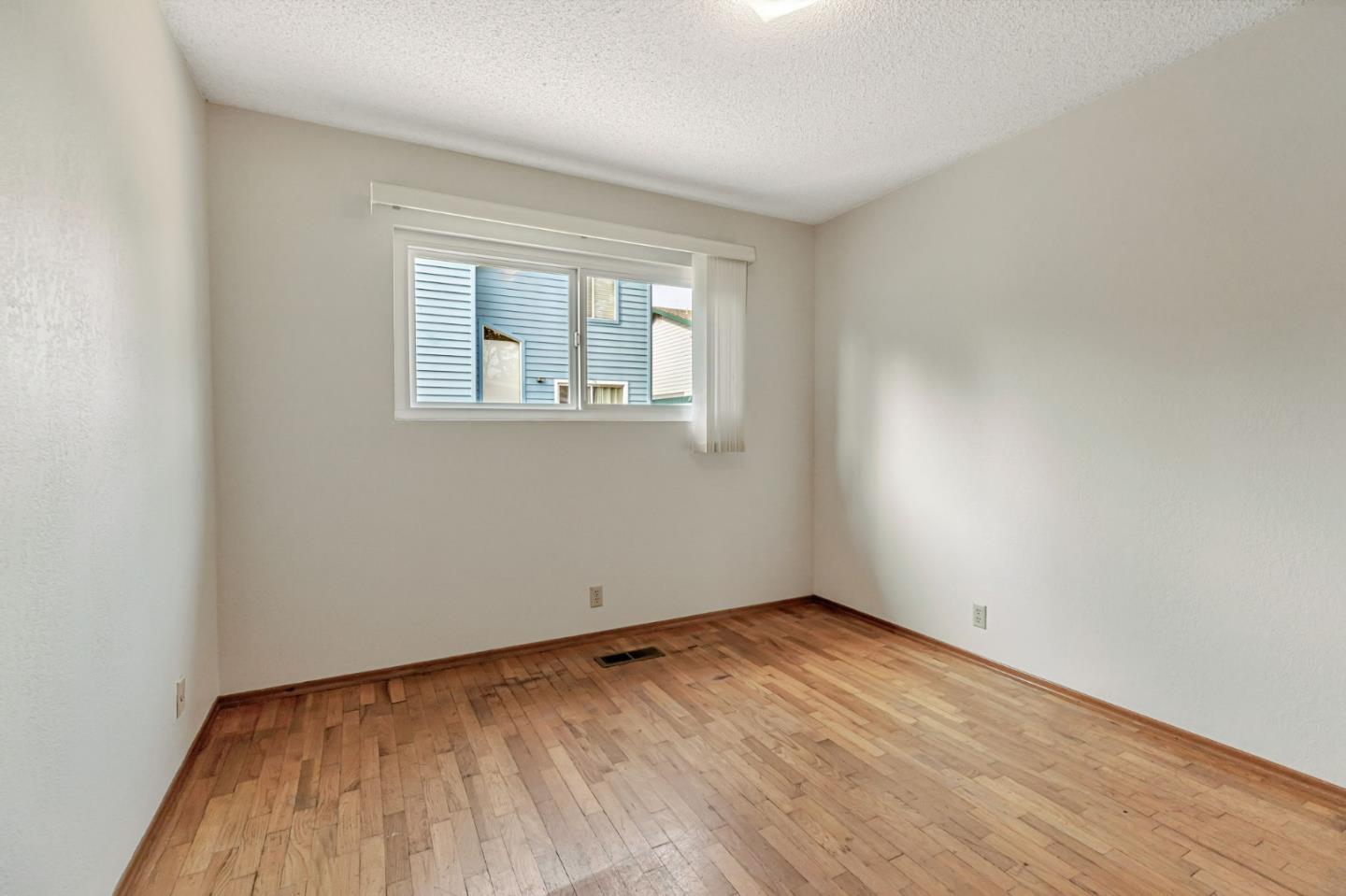 801 Lobos Street Monterey, CA 93940 - Photo 28 of 43 wooden floor in an empty room with a window