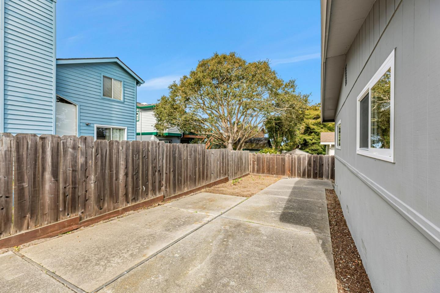 801 Lobos Street Monterey, CA 93940 - Photo 42 of 43 a view of backyard with wooden fence and trees