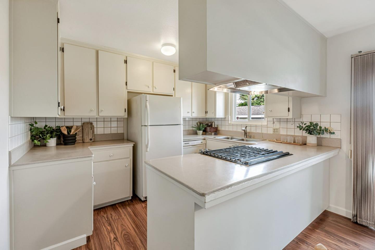 801 Lobos Street Monterey, CA 93940 - Photo 10 of 43 a kitchen with white cabinets and white appliances