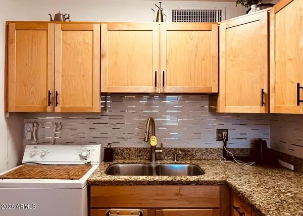 a kitchen with granite countertop a sink and a window