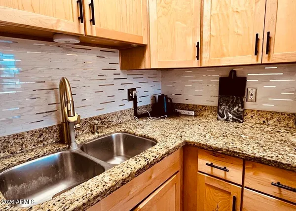 a kitchen with a sink and cabinets