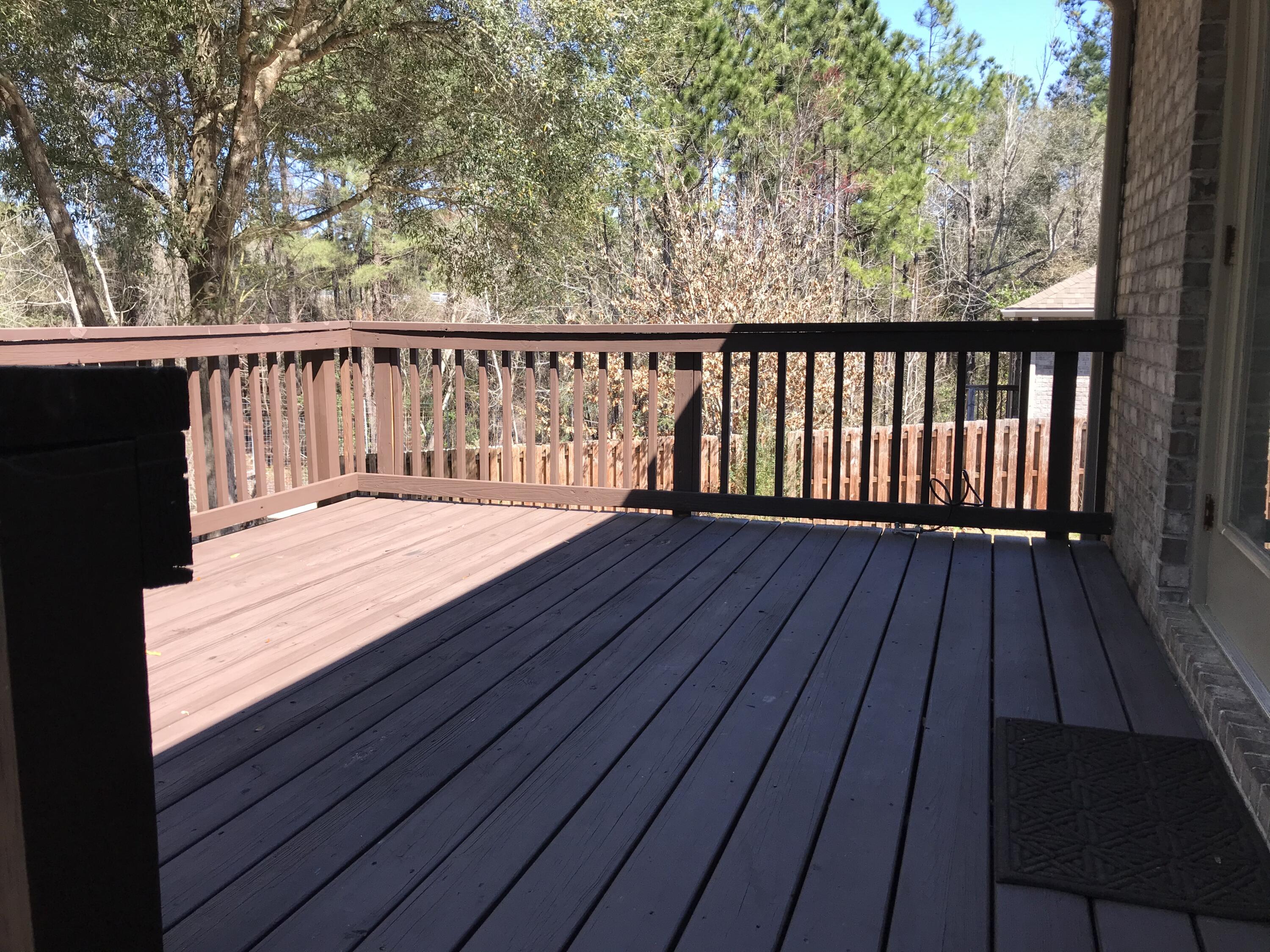 749 Lime Lane Crestview, FL 32536 - Photo 13 of 14 a balcony with wooden floor and fence