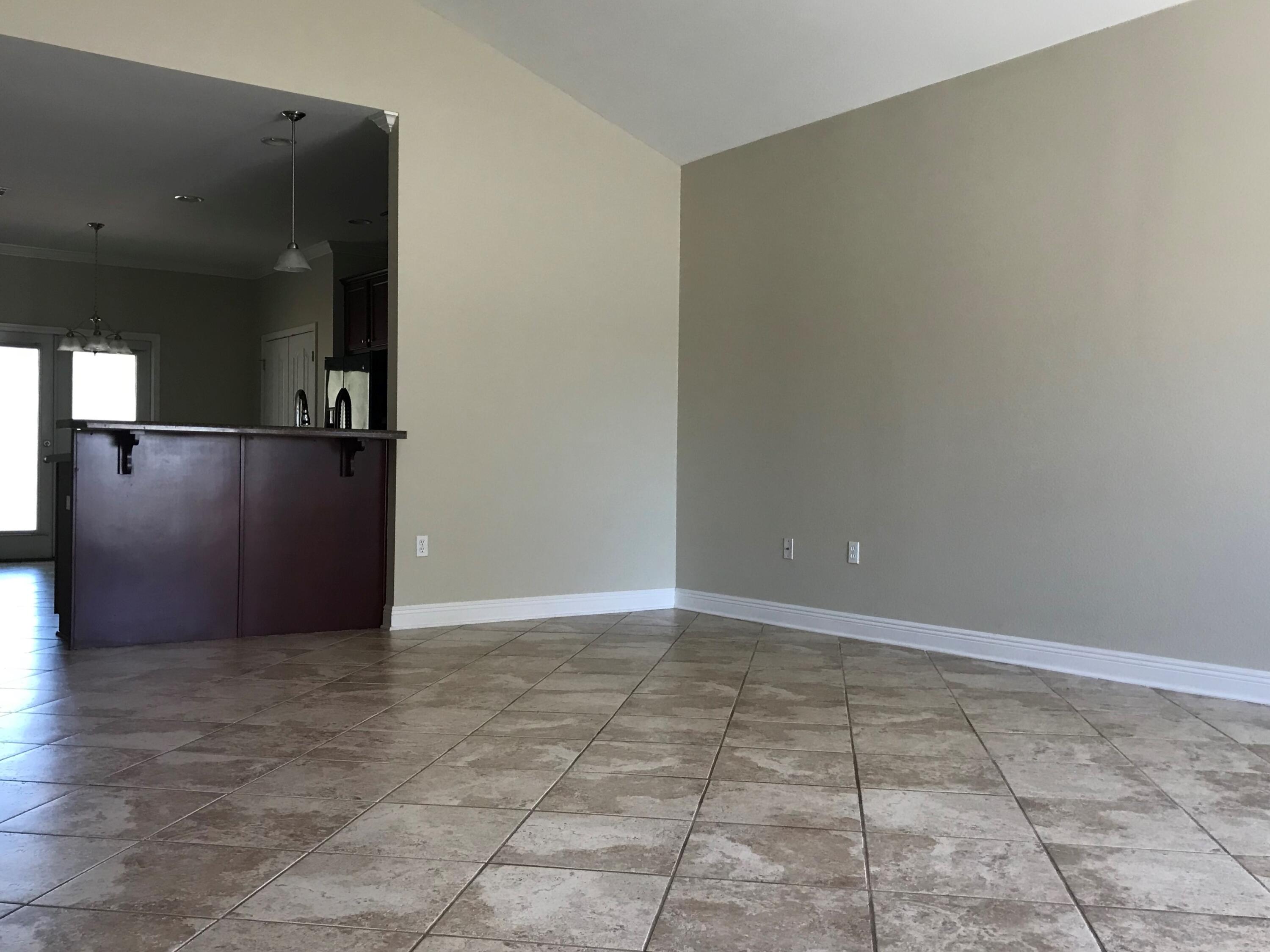 749 Lime Lane Crestview, FL 32536 - Photo 2 of 14 a view of a refrigerator in kitchen and an empty room