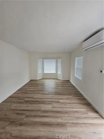 a kitchen with stainless steel appliances granite countertop a sink a stove and a wooden floors