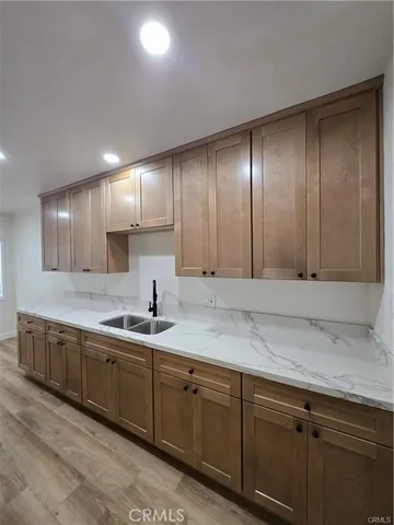 a kitchen with granite countertop stainless steel appliances and wooden cabinets