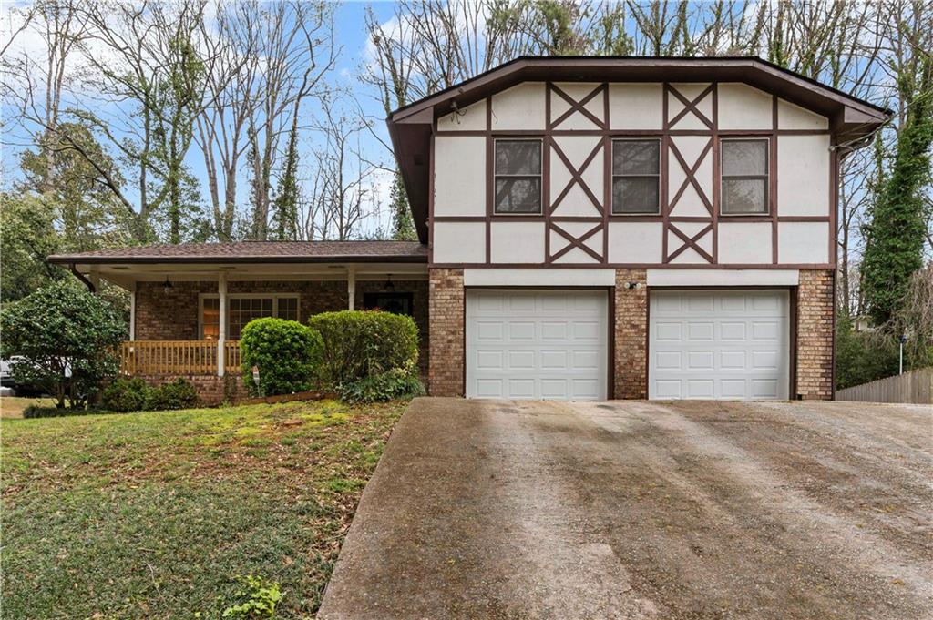 a view of a house with a yard and garage