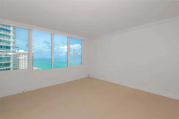 an empty room with large windows