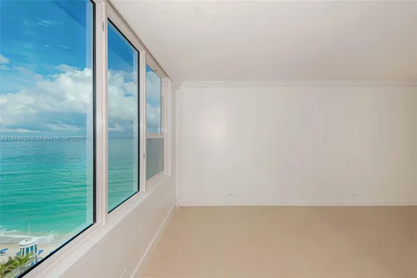 a view of a big room with wooden floor and a window