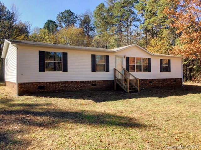 145 Loray Farm Road, Unit L2 Dallas, NC 28034 - Photo 1 of 9 a front view of a house with a yard covered with trees