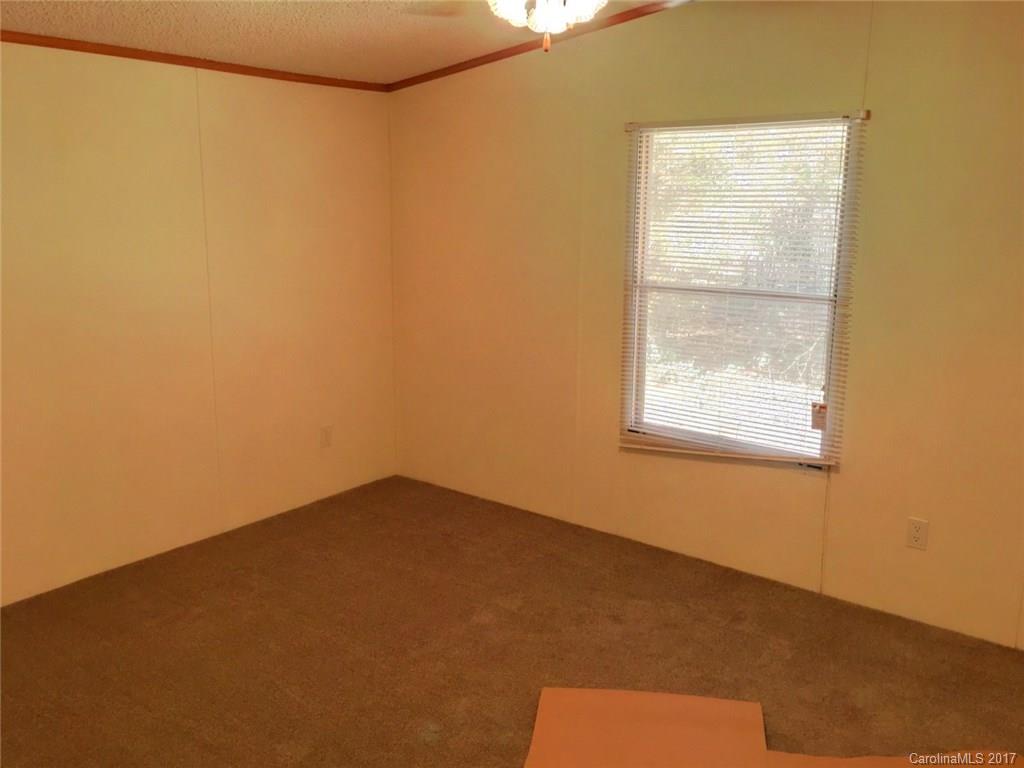 145 Loray Farm Road, Unit L2 Dallas, NC 28034 - Photo 6 of 9 a view of an empty room with a window