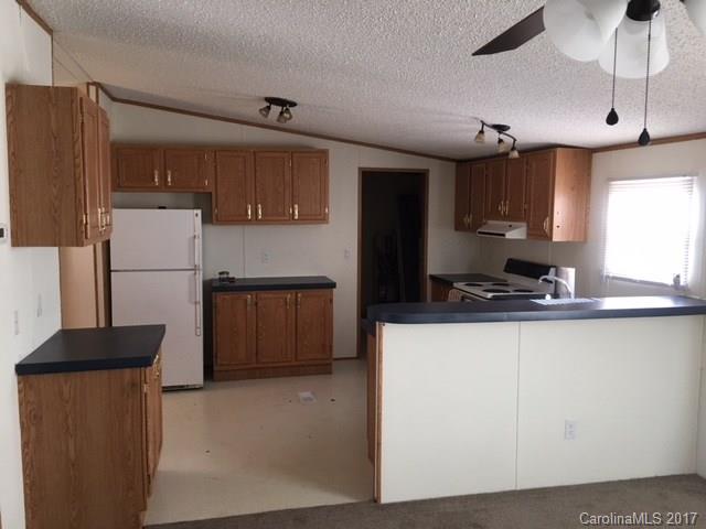 145 Loray Farm Road, Unit L2 Dallas, NC 28034 - Photo 7 of 9 a kitchen with a refrigerator a sink and cabinets