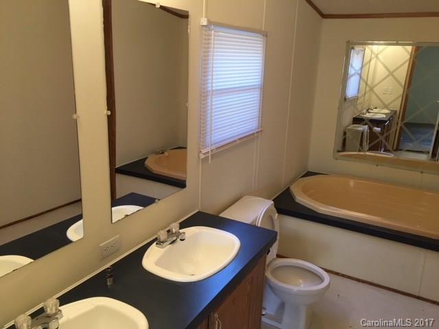 145 Loray Farm Road, Unit L2 Dallas, NC 28034 - Photo 9 of 9 a bathroom with a toilet sink and mirror