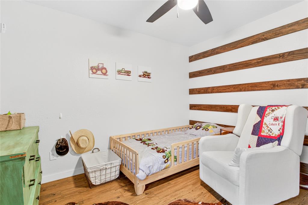 703 College Street Celeste, TX 75423 - Photo 19 of 29 a bedroom with a bed and ceiling fan