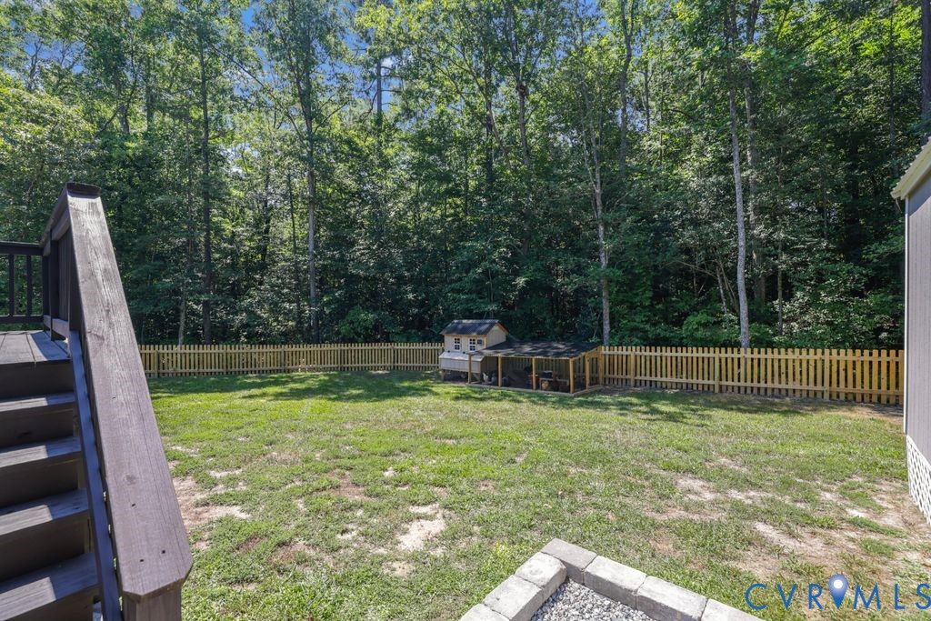 222 Oak Ridge Court Aylett, VA 23009 - Photo 29 of 35 Expansive backyard featuring a lush lawn, a light