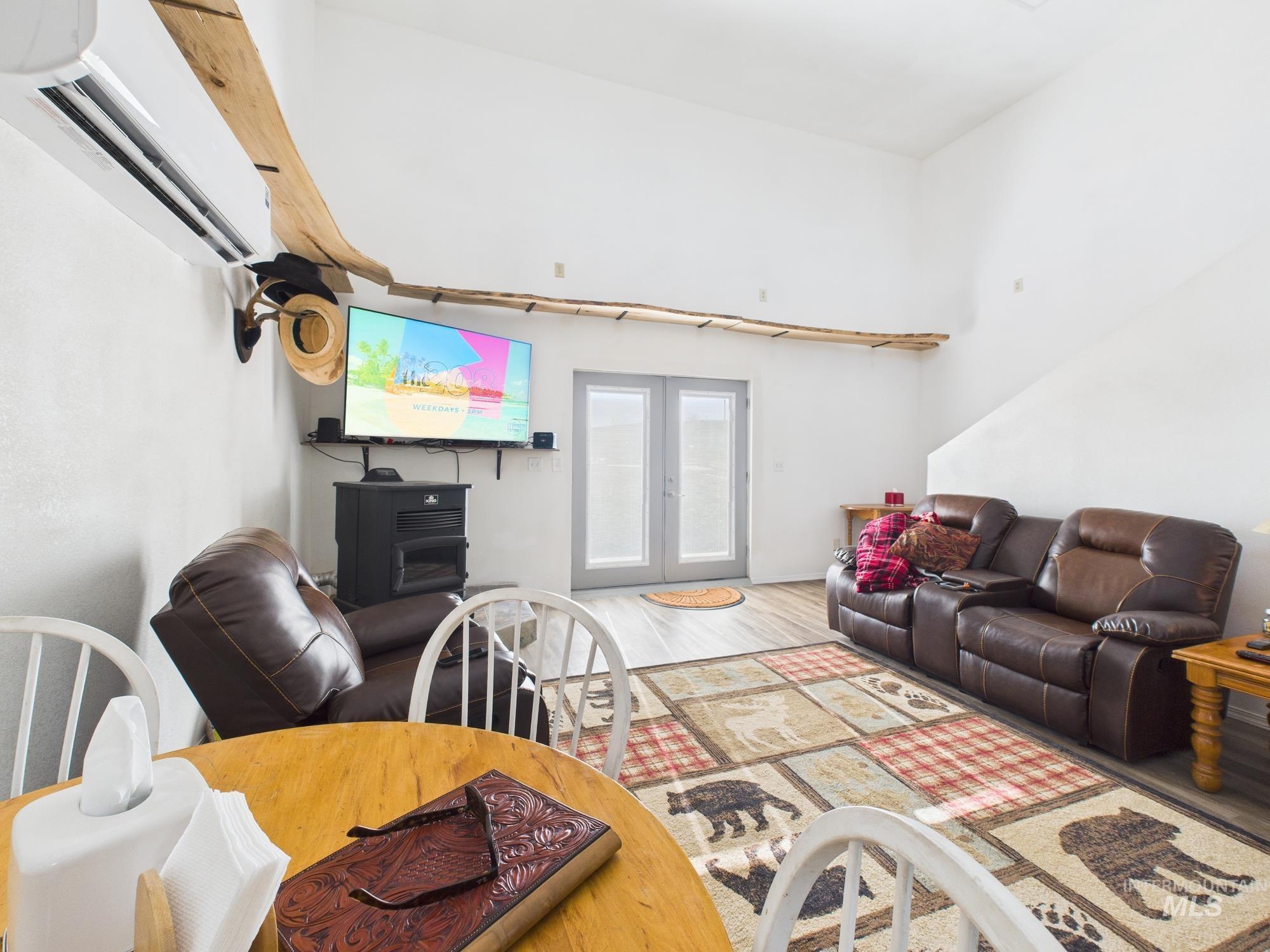 1086 Highland Lane Mesa, ID 83643 - Photo 12 of 45 Living room with light wood finished floors, a high ceiling, and french doors