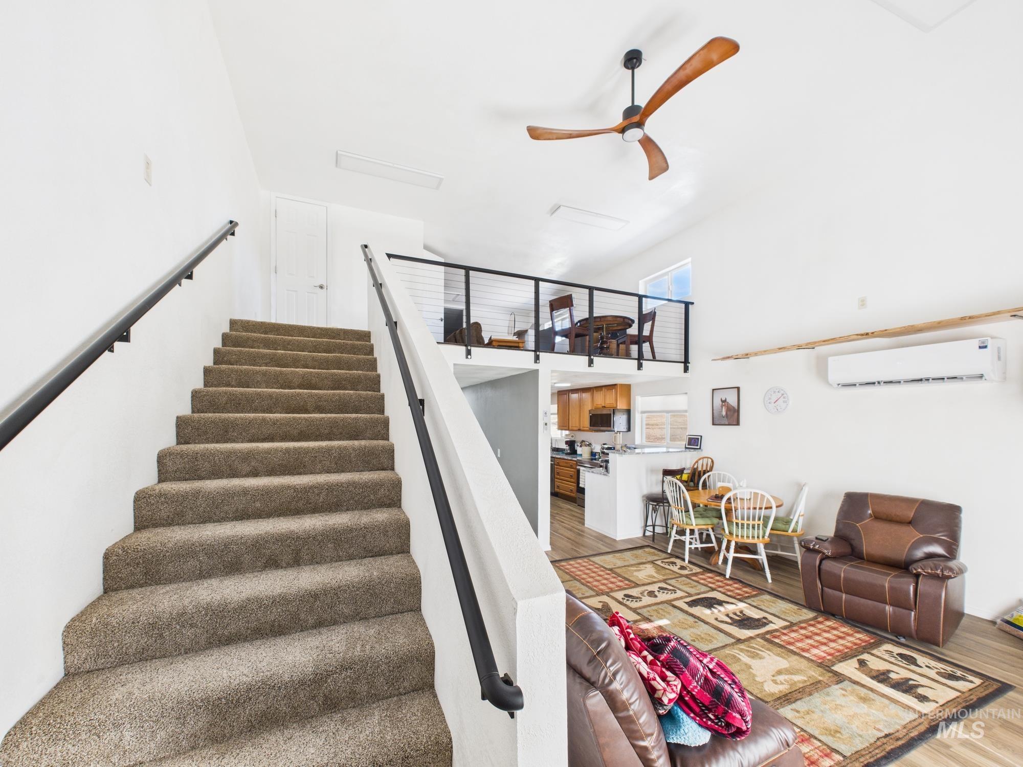 1086 Highland Lane Mesa, ID 83643 - Photo 14 of 45 Stairway with a ceiling fan, a high ceiling, and wood finished floors