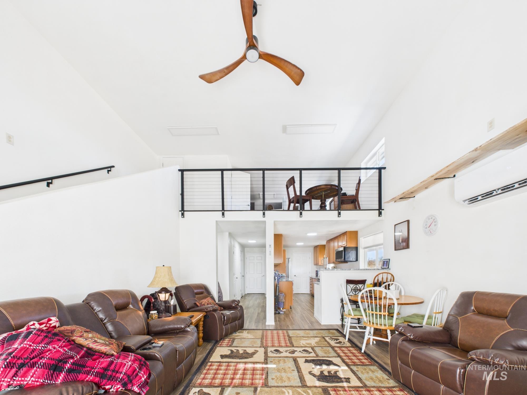 1086 Highland Lane Mesa, ID 83643 - Photo 15 of 45 Living area with ceiling fan, light wood-style flooring, and a high ceiling