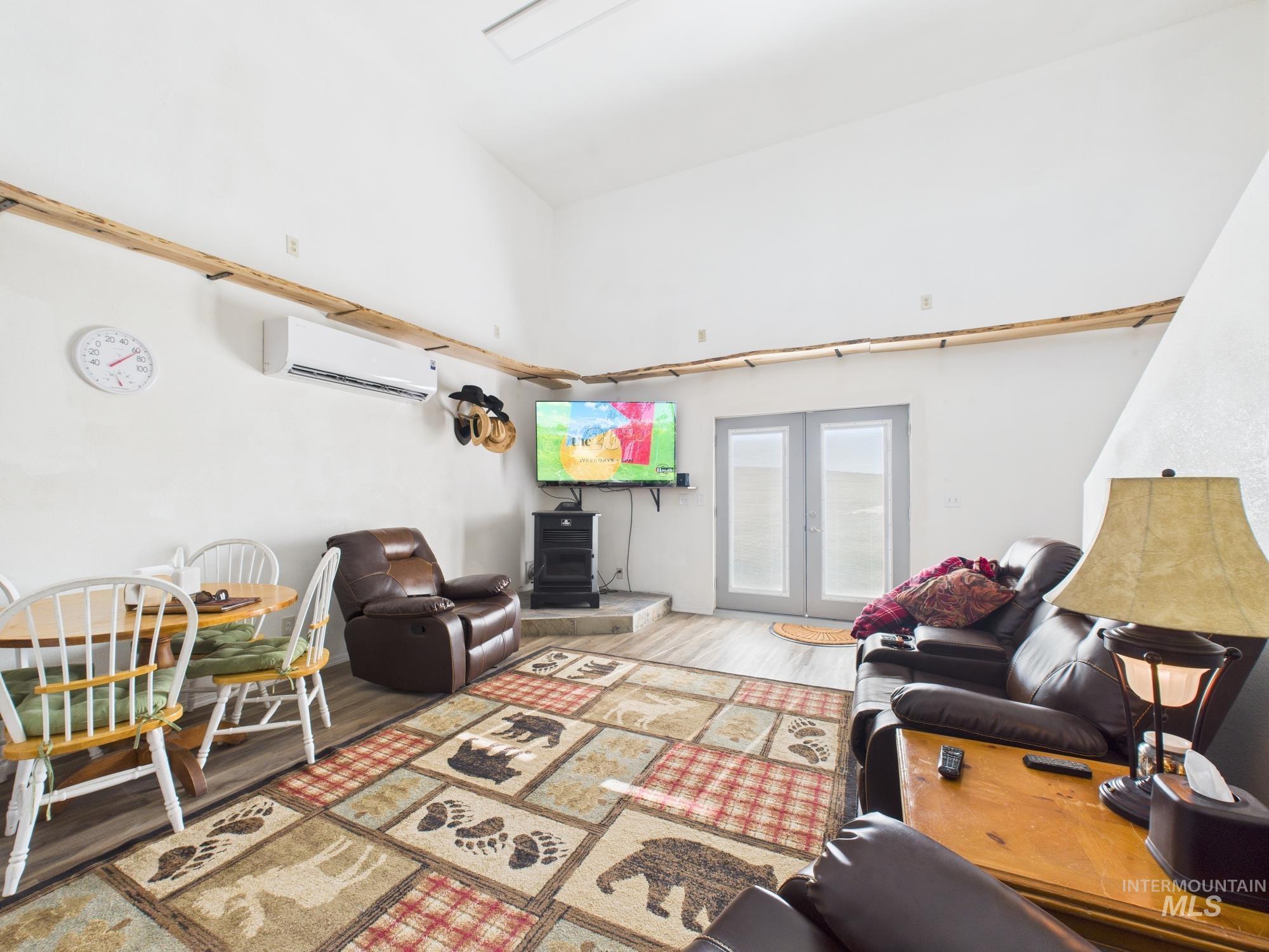 1086 Highland Lane Mesa, ID 83643 - Photo 17 of 45 Living area featuring wood finished floors, french doors, and a mini split for heating / cooling