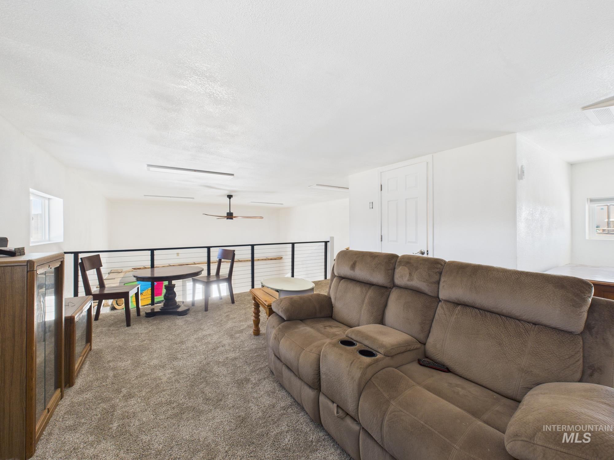 1086 Highland Lane Mesa, ID 83643 - Photo 20 of 45 Carpeted living area with plenty of natural light and a ceiling fan
