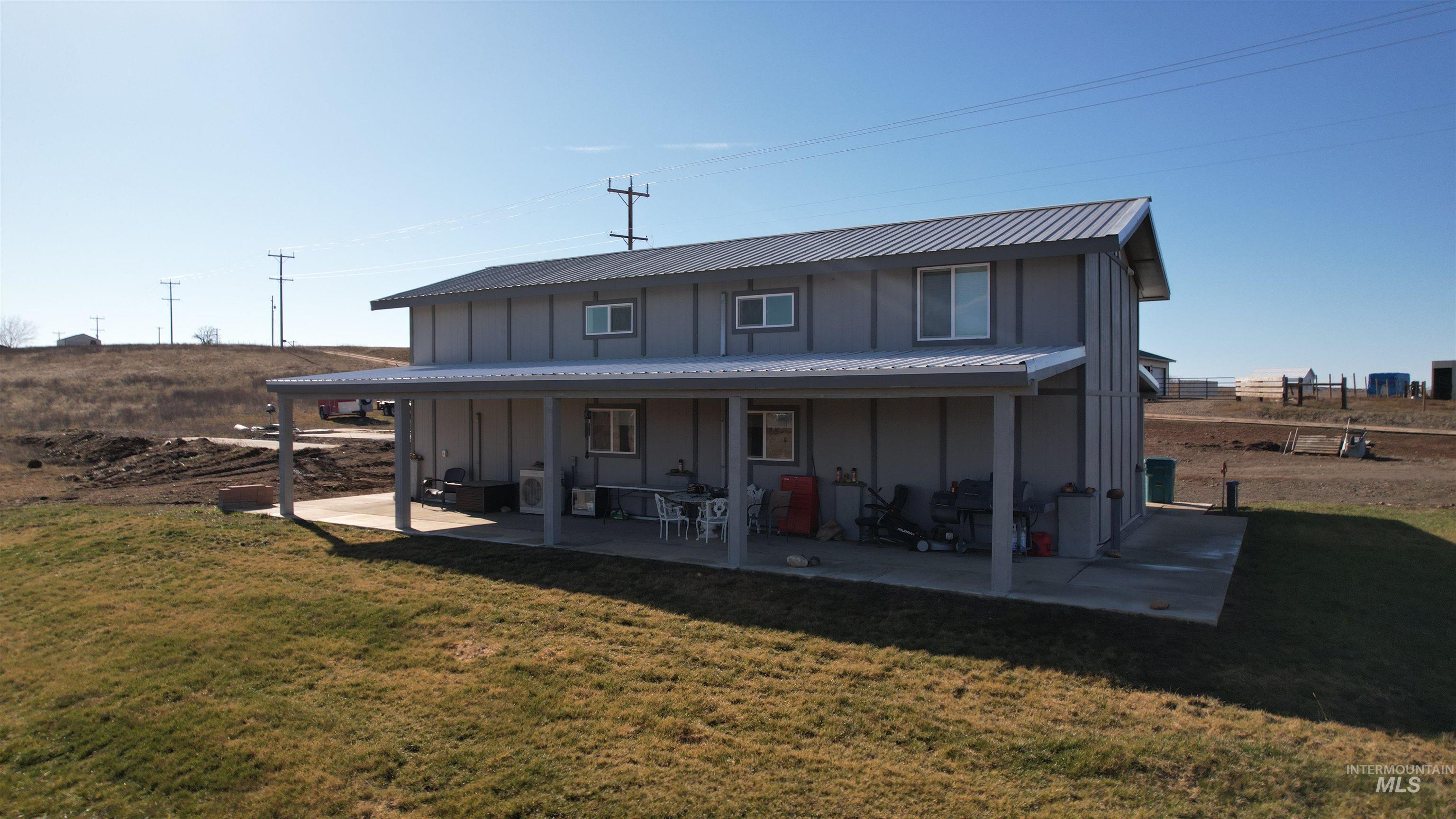 1086 Highland Lane Mesa, ID 83643 - Photo 3 of 45 Back of house with board and batten siding, a yard, and covered porch