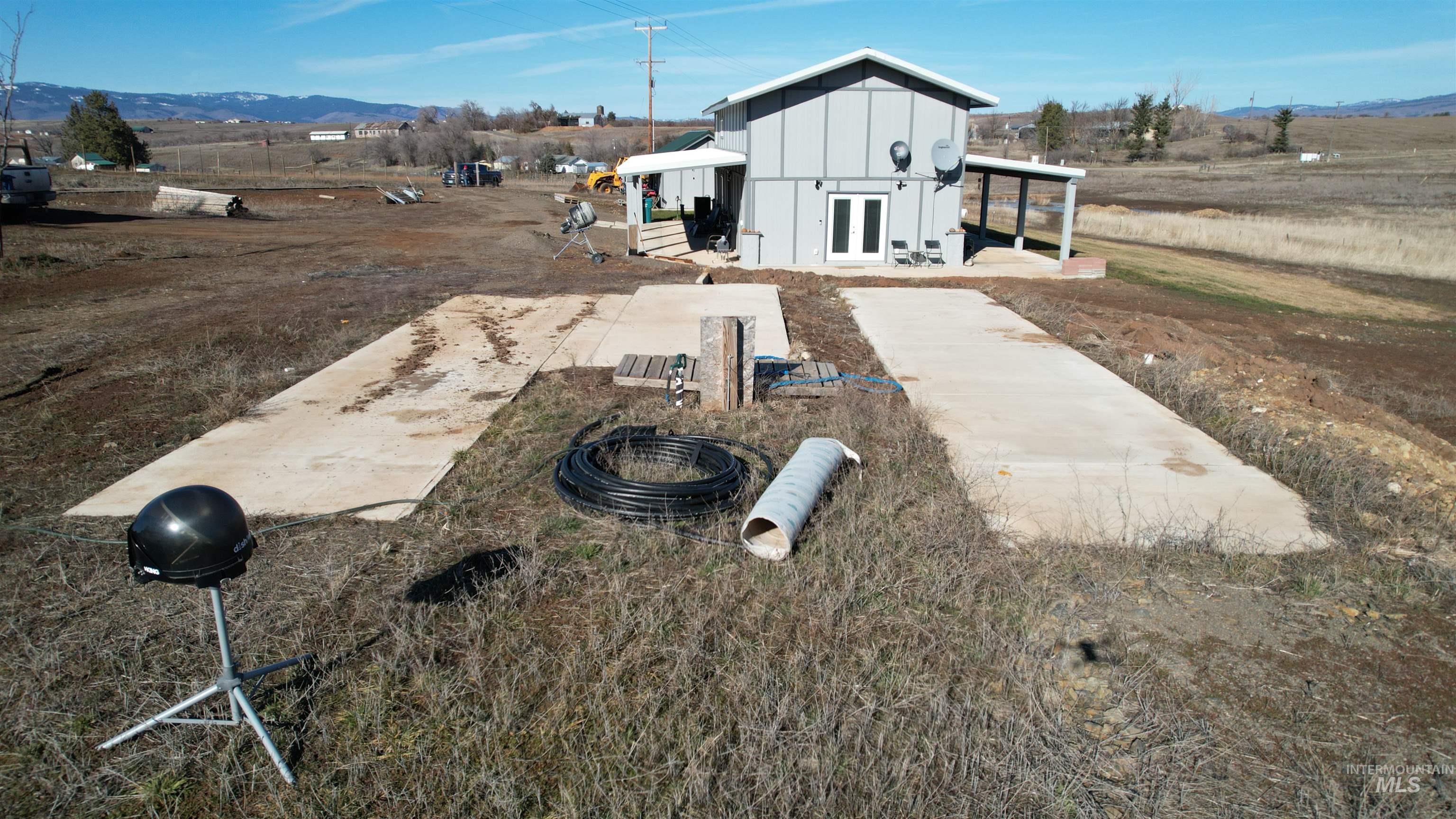 1086 Highland Lane Mesa, ID 83643 - Photo 36 of 45 View of front facade featuring a mountain view, board and batten siding, and an outbuilding