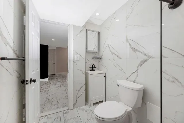 a white toilet sitting next to a bathroom sink