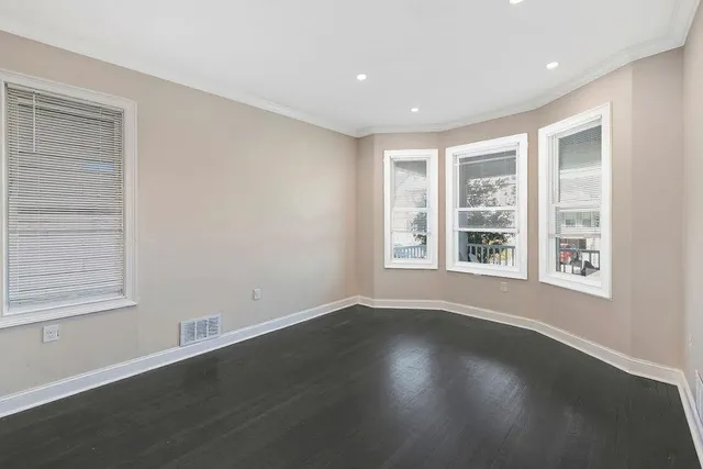 a view of wooden floor and windows in a room
