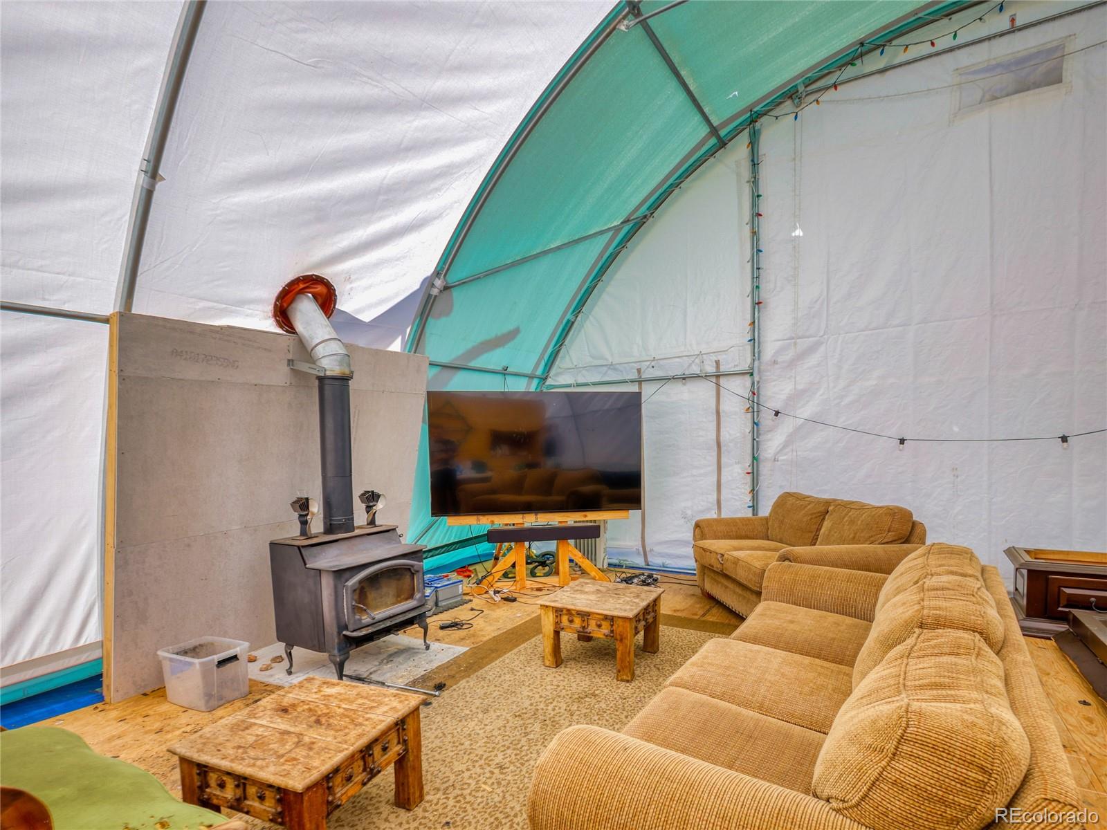 0 Indian Springs Road Morrison, CO 80465 - Photo 6 of 28 a projector room with a couch and a flat screen tv