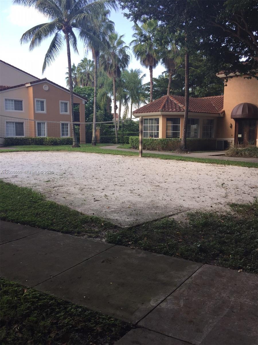2103 Renaissance Boulevard, Unit 104 Miramar, FL 33025 - Photo 11 of 12 a front view of a house with a yard and trees