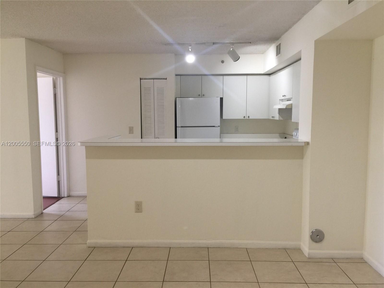 2103 Renaissance Boulevard, Unit 104 Miramar, FL 33025 - Photo 2 of 12 a view of a kitchen with white cabinets