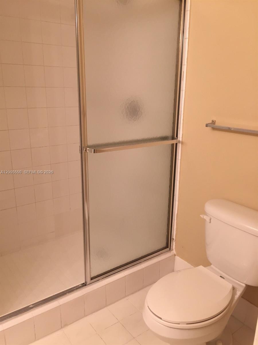 2103 Renaissance Boulevard, Unit 104 Miramar, FL 33025 - Photo 5 of 12 a white toilet sitting next to a shower