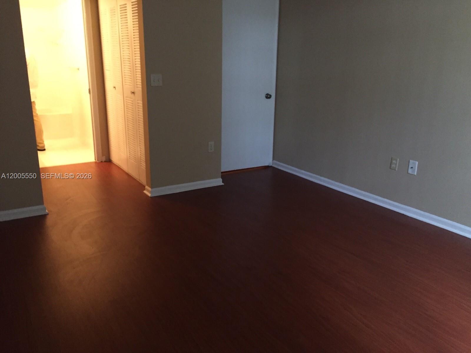 2103 Renaissance Boulevard, Unit 104 Miramar, FL 33025 - Photo 6 of 12 a view of a room with wooden floor and a window