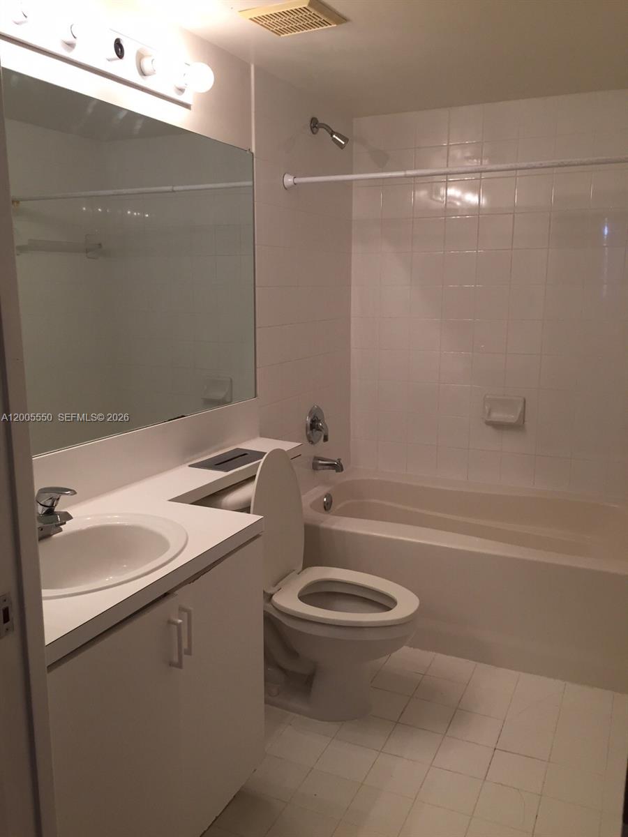 2103 Renaissance Boulevard, Unit 104 Miramar, FL 33025 - Photo 7 of 12 a bathroom with a sink a toilet and shower