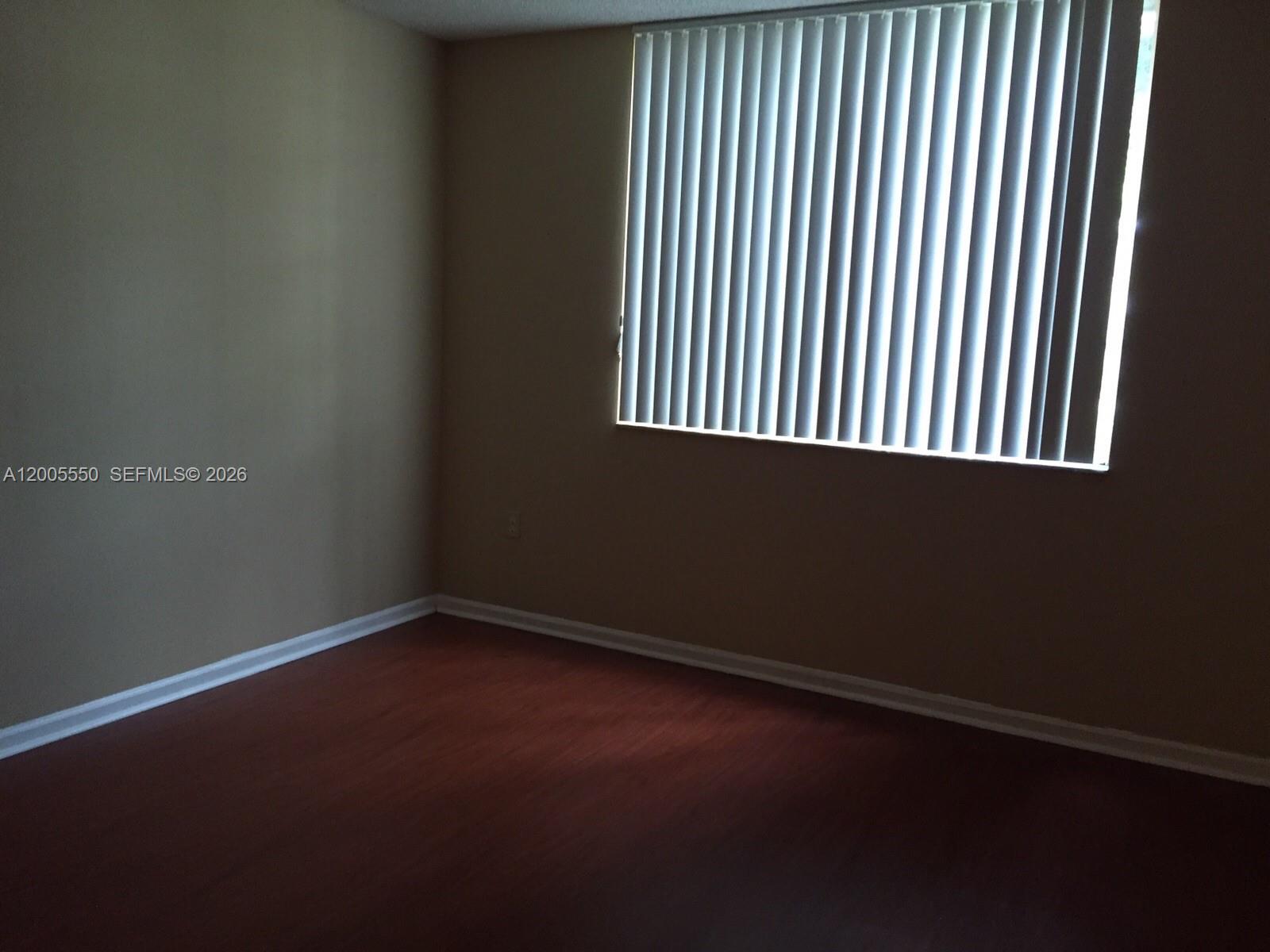 2103 Renaissance Boulevard, Unit 104 Miramar, FL 33025 - Photo 8 of 12 an empty room with a window