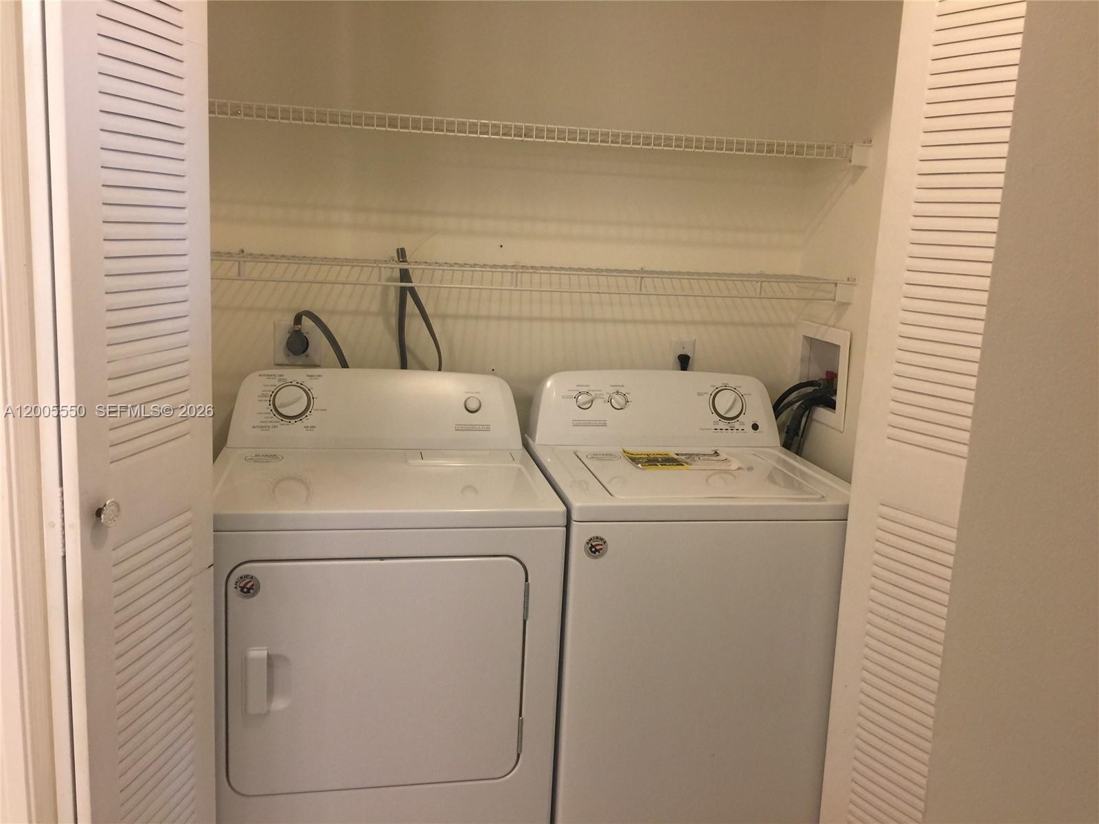 2103 Renaissance Boulevard, Unit 104 Miramar, FL 33025 - Photo 9 of 12 a utility room with dryer and washer