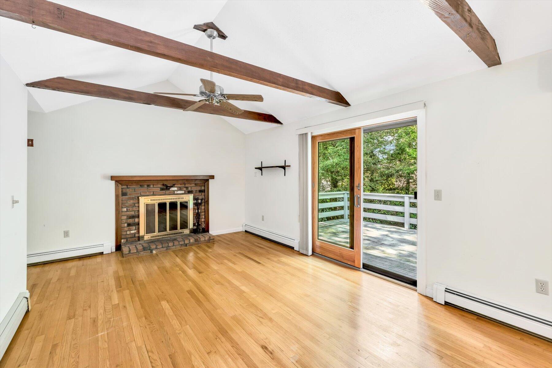 97 Headwaters Road Centerville, MA 02632 - Photo 13 of 44 a view of a livingroom with wooden floor and a ceiling fan