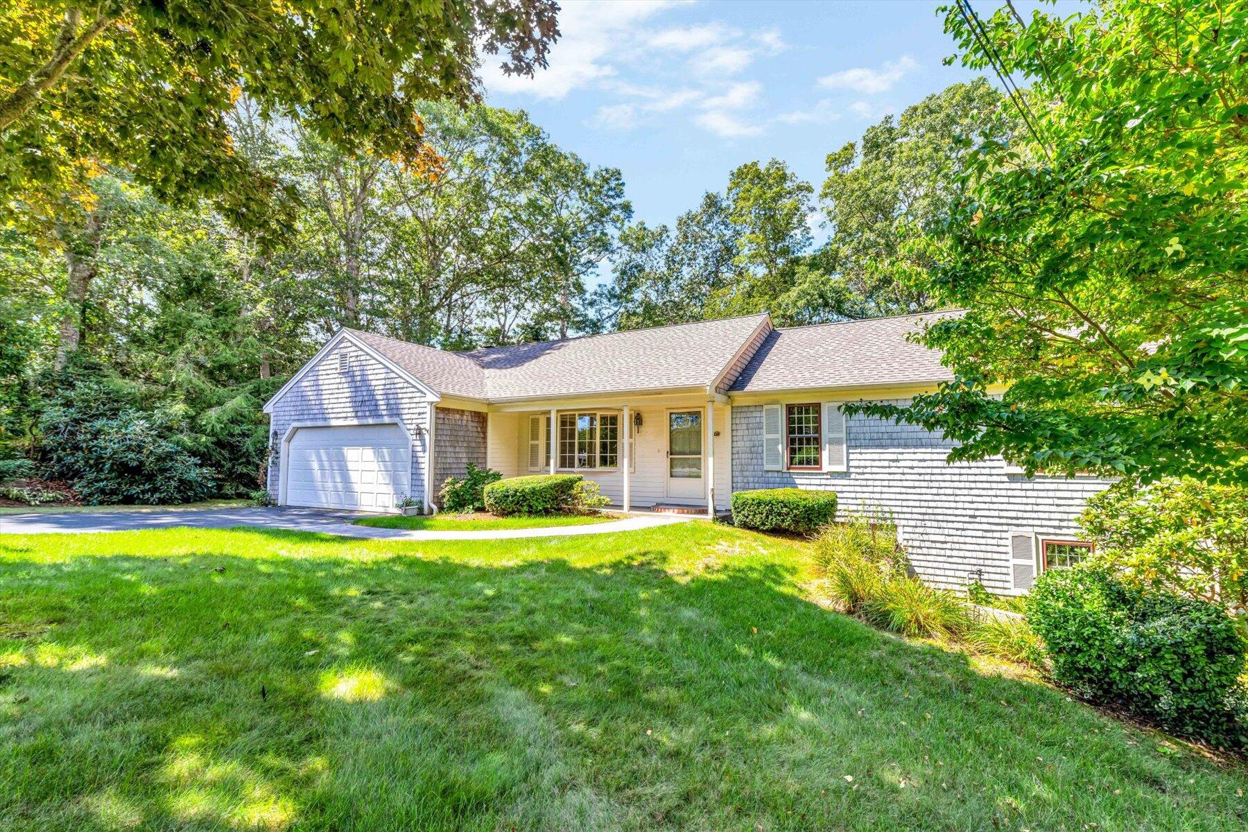 97 Headwaters Road Centerville, MA 02632 - Photo 2 of 44 a front view of a house with swimming pool having outdoor seating