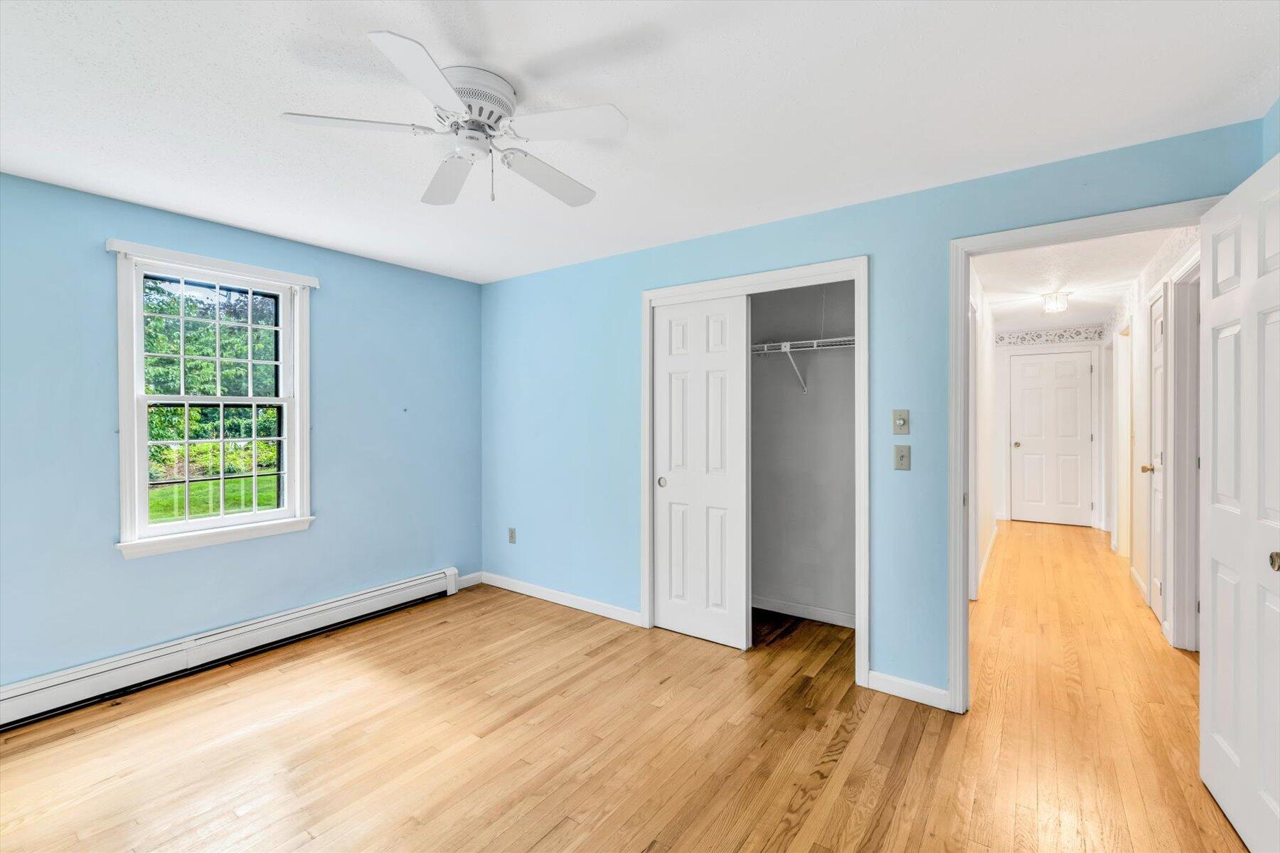 97 Headwaters Road Centerville, MA 02632 - Photo 24 of 44 an empty room with wooden floor and a ceiling fan